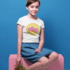 cute girl sitting with white sweet pink donut tshirt