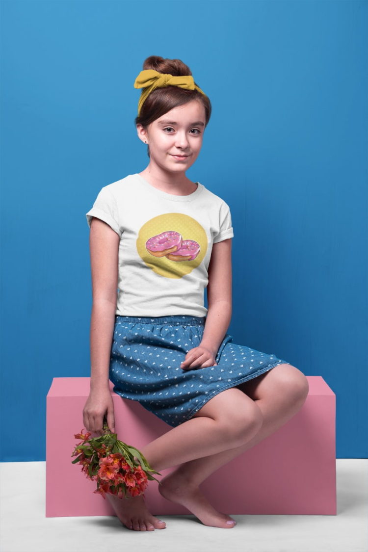 cute girl sitting with white sweet pink donut tshirt