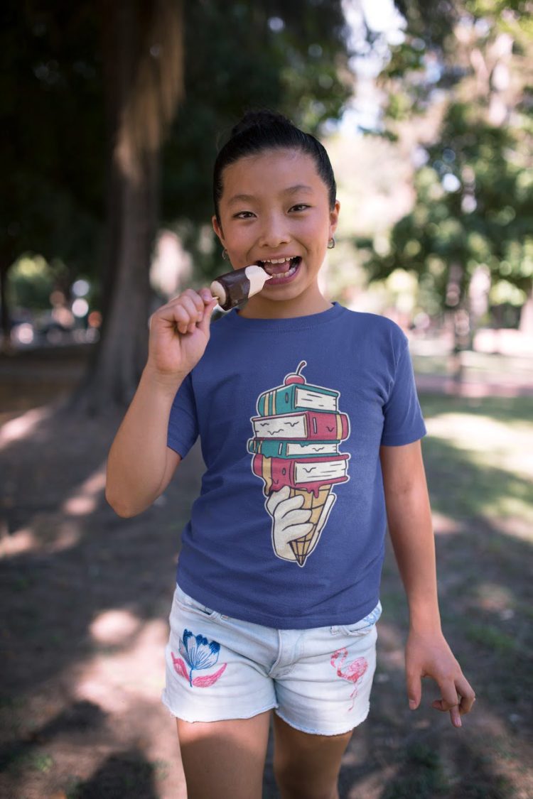 girl in the park in deep blue ice cream cone with books tshirt