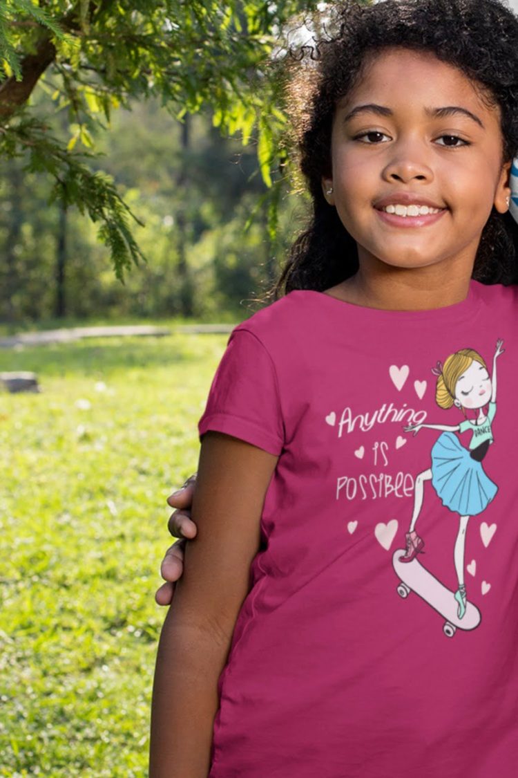 smiling girl wearing Anything is possible girl on skateboard dark pink tshirt