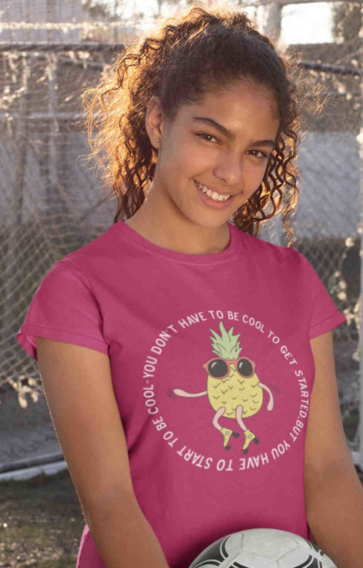 cool girl in dark pink tshirt with Cool Pineapple skating cartoon