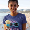 smiling girl in deep blue tshirt with Cute kitty in sunglasses - it's meow or never