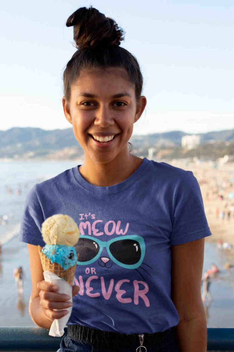 smiling girl in deep blue tshirt with Cute kitty in sunglasses - it's meow or never