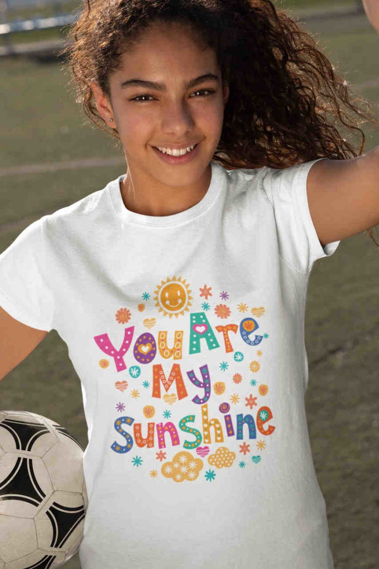 girl holding football wearing You are my Sunshine White tshirt