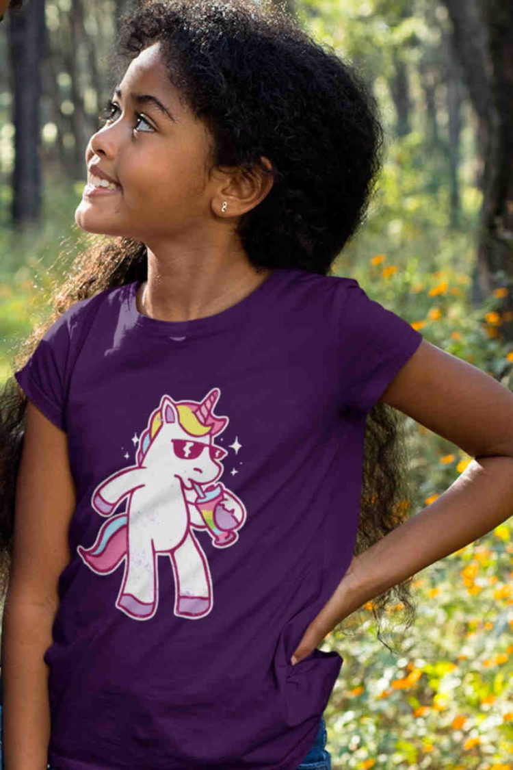 happy girl in purple tshirt with Unicorn drinking a shake