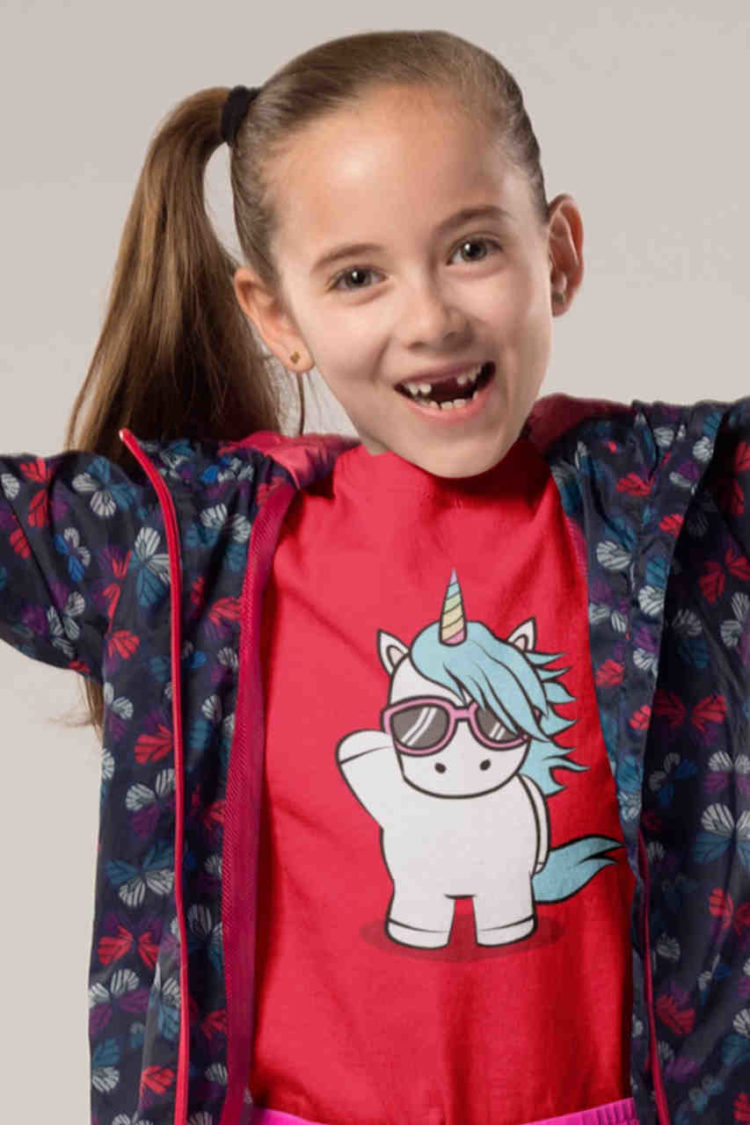 happy girl in red tshirt with unicorn wearing sunglasses