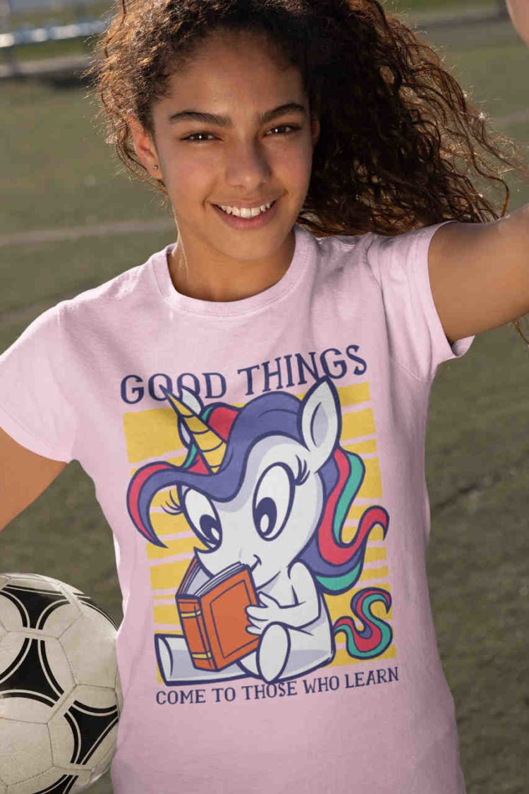 sporty girl in light pijnk tshirt with Unicorn reading a book