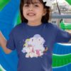 cute girl in deep blue tshirt with Unicorn with party streamers