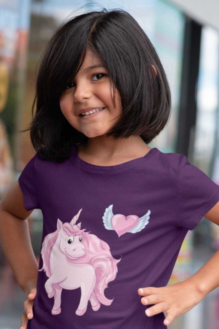 cute girl in purple tshirt with Pink Unicorn with heart with wings