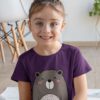 smiling girl in purple tshirt with cute bear