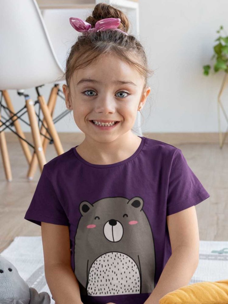smiling girl in purple tshirt with cute bear