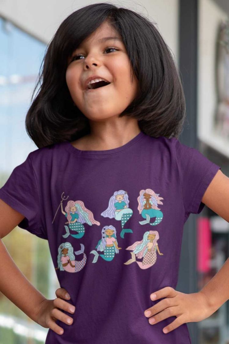 happy girl in a Purple tshirt with Six mermaids swimming