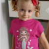 beautiful girl in a dark pink tshirt with a mermaid and seahorse