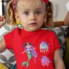 sweet girl in a red tshirt with a Pirate Mermaid and jellyfish