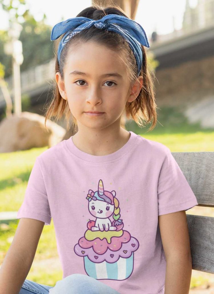 lovely girl in a light pink tshirt with a Unicorn on a cupcake