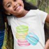 smiling girl in a white tshirt with a Stack of Macarons