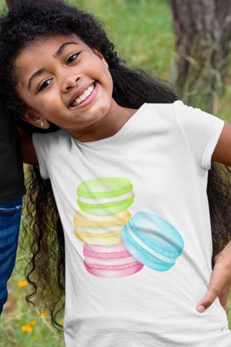 smiling girl in a white tshirt with a Stack of Macarons