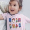 little girl in light pink tshirt with a set of popsicles