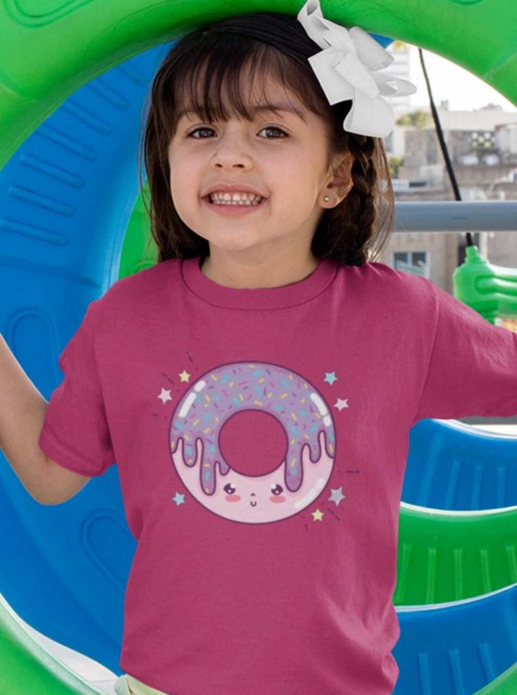 smiling girl in a dark pink tshirt with a pink purple smiling donut