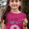 Cute girl in a dark pink tshirt with Anatomy of a perfect donut