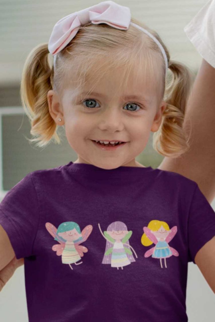 happy little girl in a purple tshirt with Three little fairies
