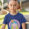 smart little girl in a deep blue tshirt with a fairy wearing a crown