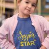 little girl in a deep blue Super Star tshirt