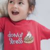 Little girl happy in a Red Donut Stress Tshirt