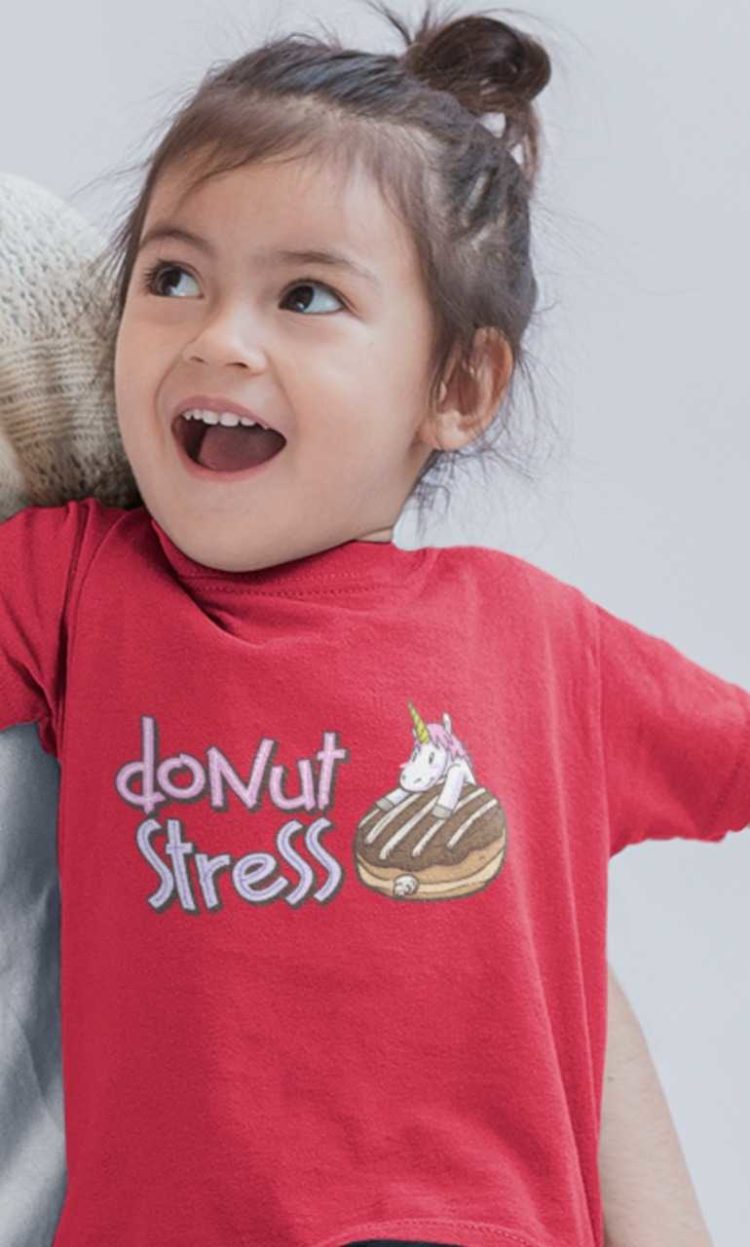 Little girl happy in a Red Donut Stress Tshirt