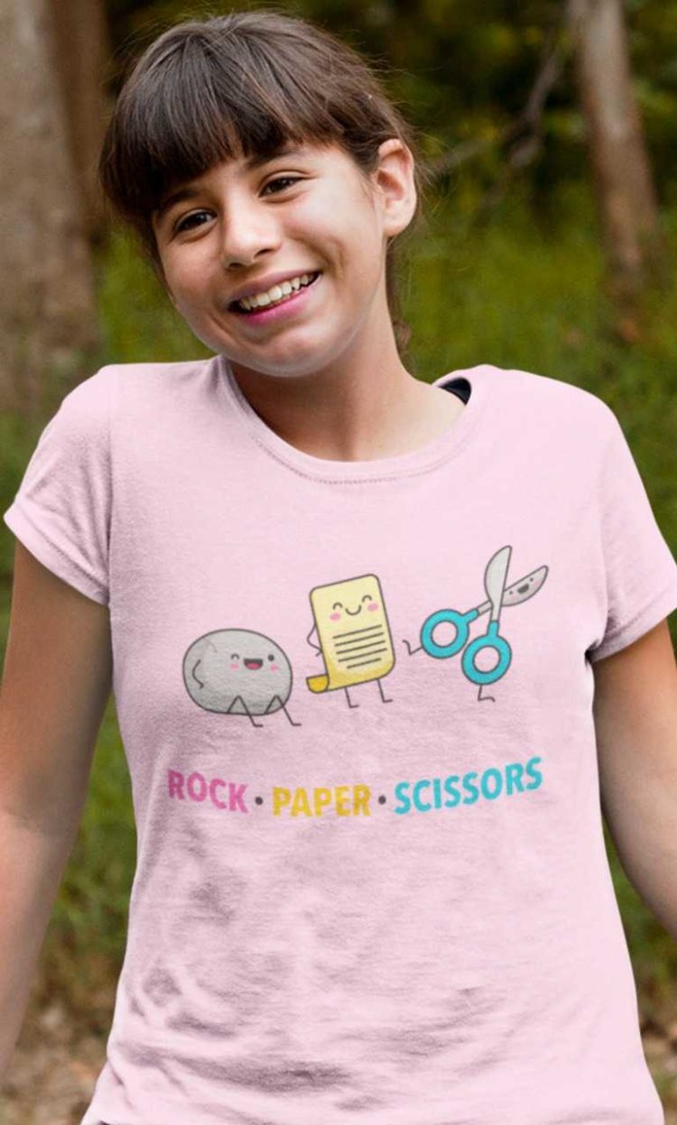 cute girl in a light pink rock paper scissors tshirt