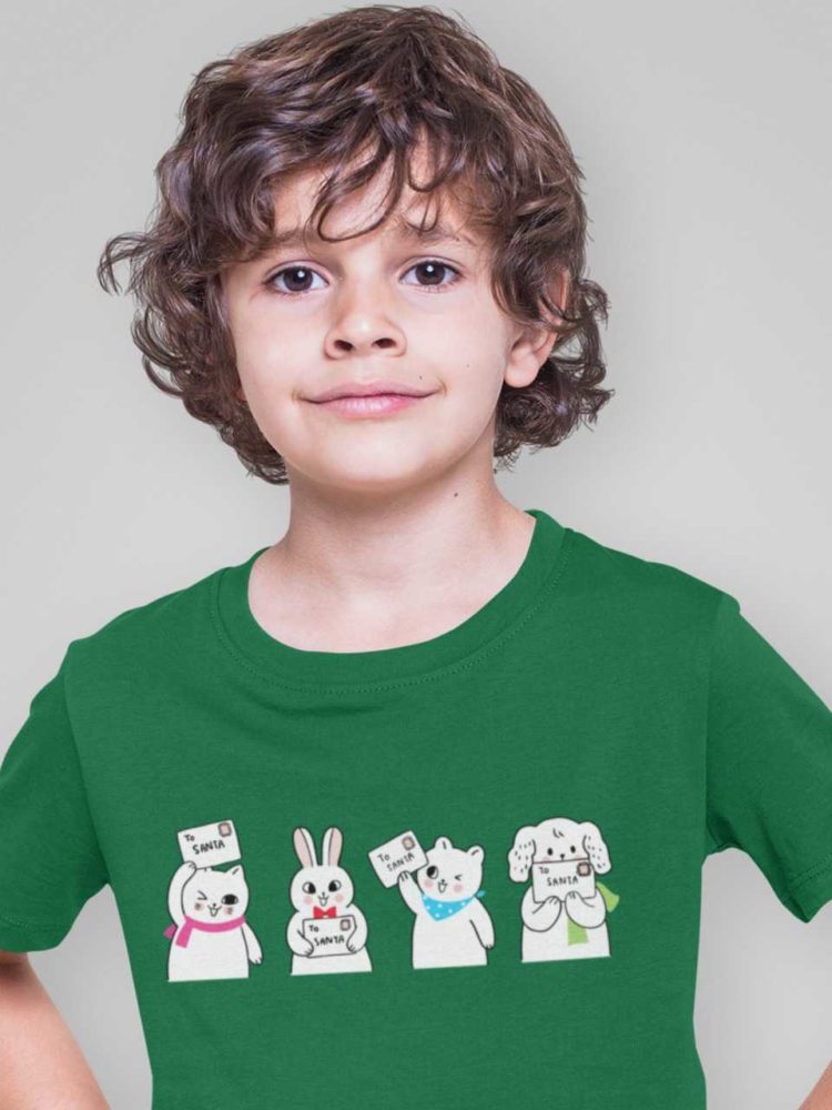 cute boy in a green tshirt with animals holding letter to santa