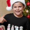 happy boy in a black tshirt with animals holding letter to santa