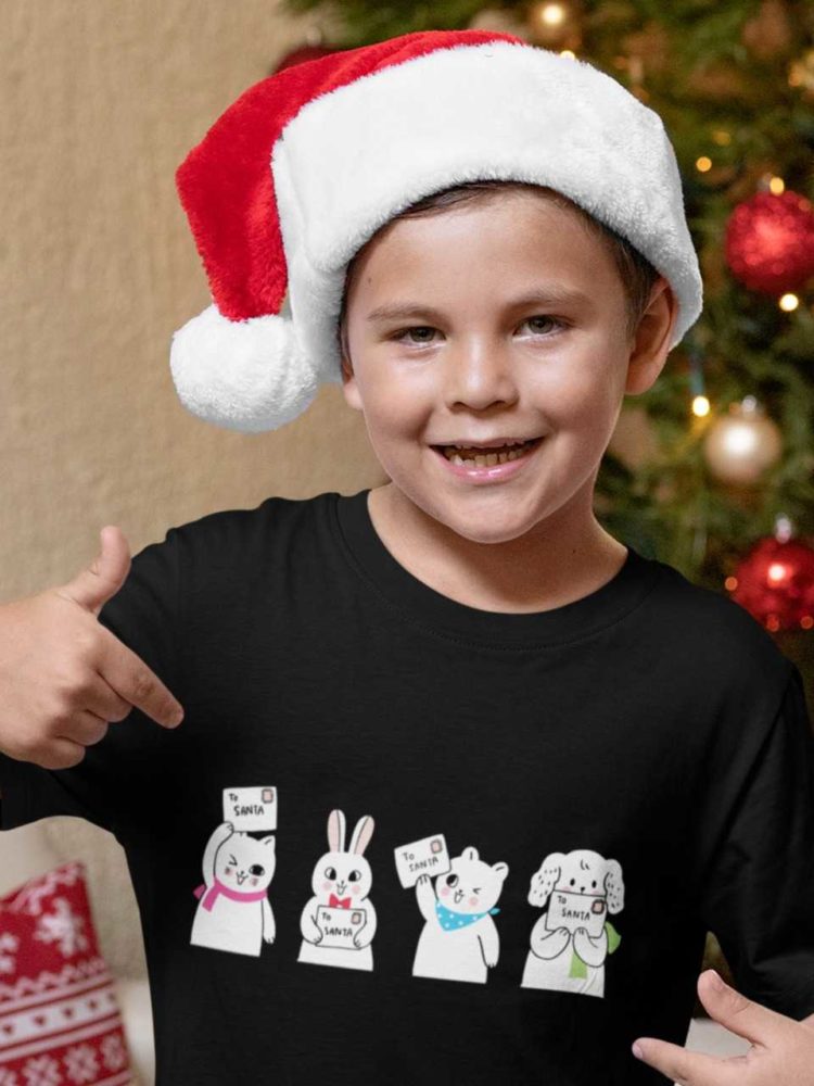 happy boy in a black tshirt with animals holding letter to santa