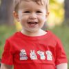 sweet little boy in a red tshirt with animals holding letter to santa