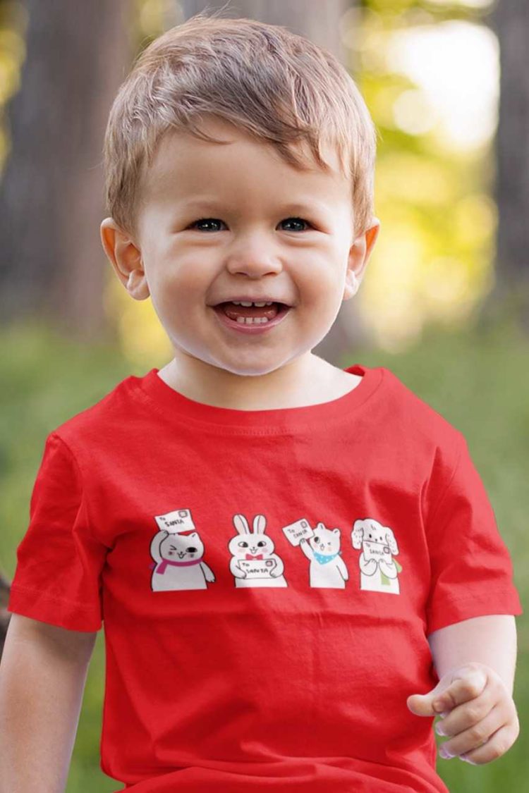 sweet little boy in a red tshirt with animals holding letter to santa