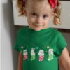 cute girl in a green tshirt with animals in Christmas stockings