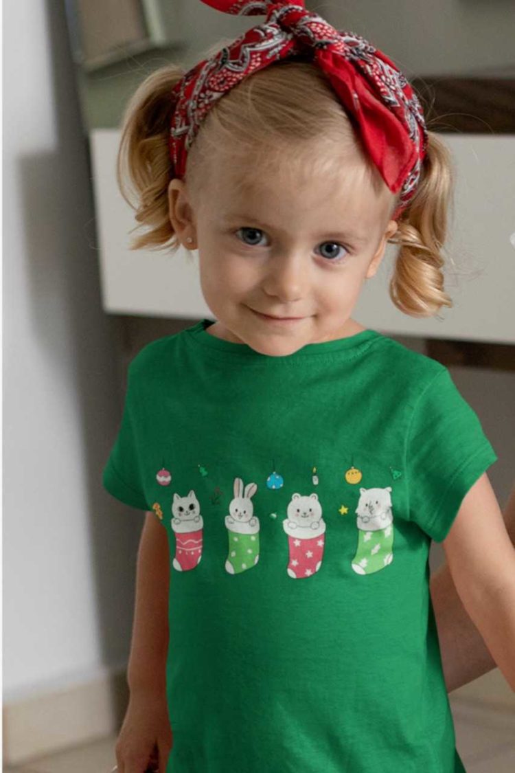 cute girl in a green tshirt with animals in Christmas stockings