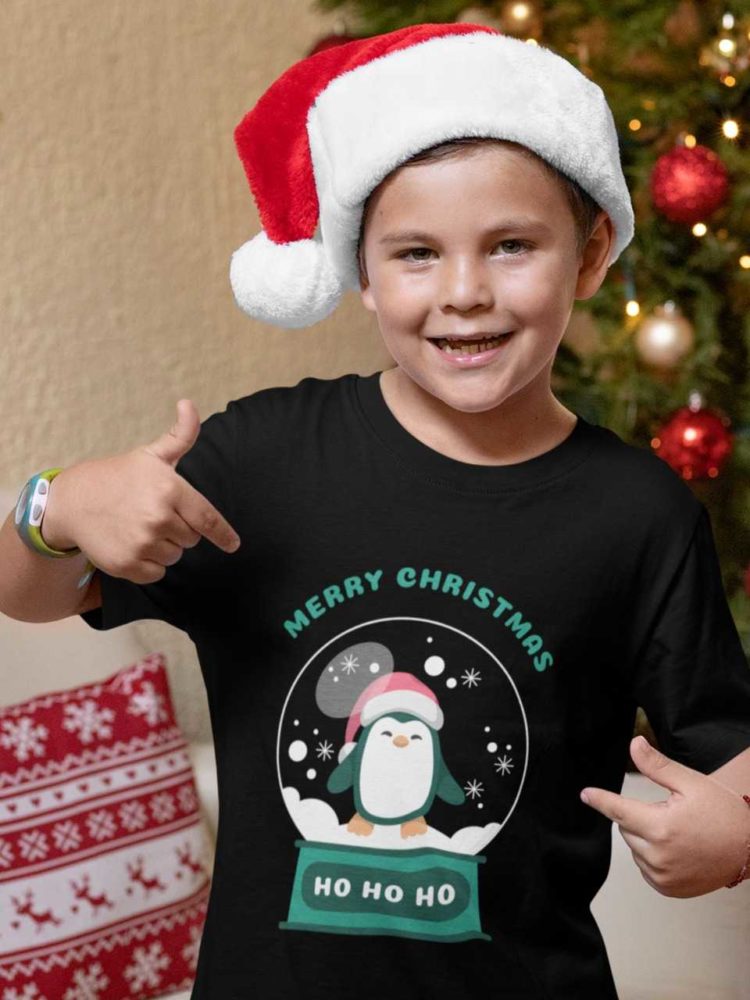 Cool boy in a black tshirt with a penguin inside a snow globe