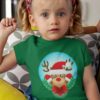 cute girl in a green tshirt with a Reindeer wearing a santa hat