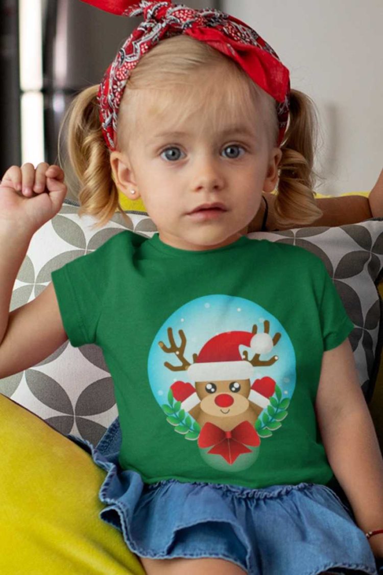 cute girl in a green tshirt with a Reindeer wearing a santa hat