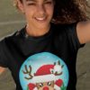 pretty girl in a black tshirt with a Reindeer wearing a santa hat