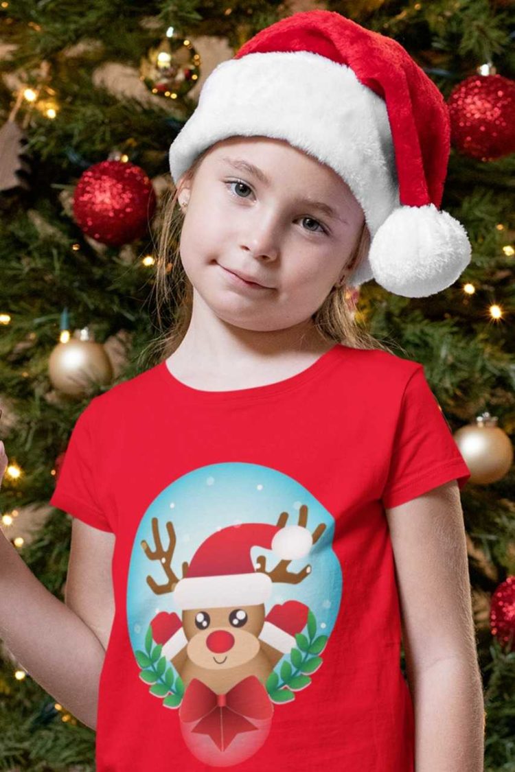 sweet girl in a red tshirt with a Reindeer wearing a santa hat