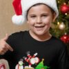 sweet boy in a black tshirt with Santa, snowman and elf on chimney