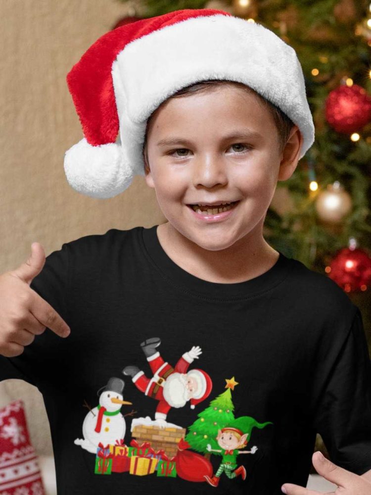 sweet boy in a black tshirt with Santa, snowman and elf on chimney