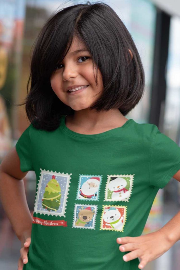 pretty girl in a green tshirt with Santa , reindeer, snowman on postage stamps