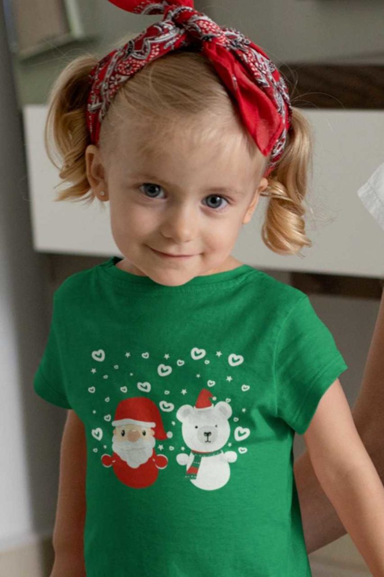 cute girl in a green tshirt with Santa and a Bear