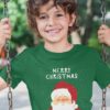 Smiling boy in a green tshirt with Santa and a Merry Christmas background