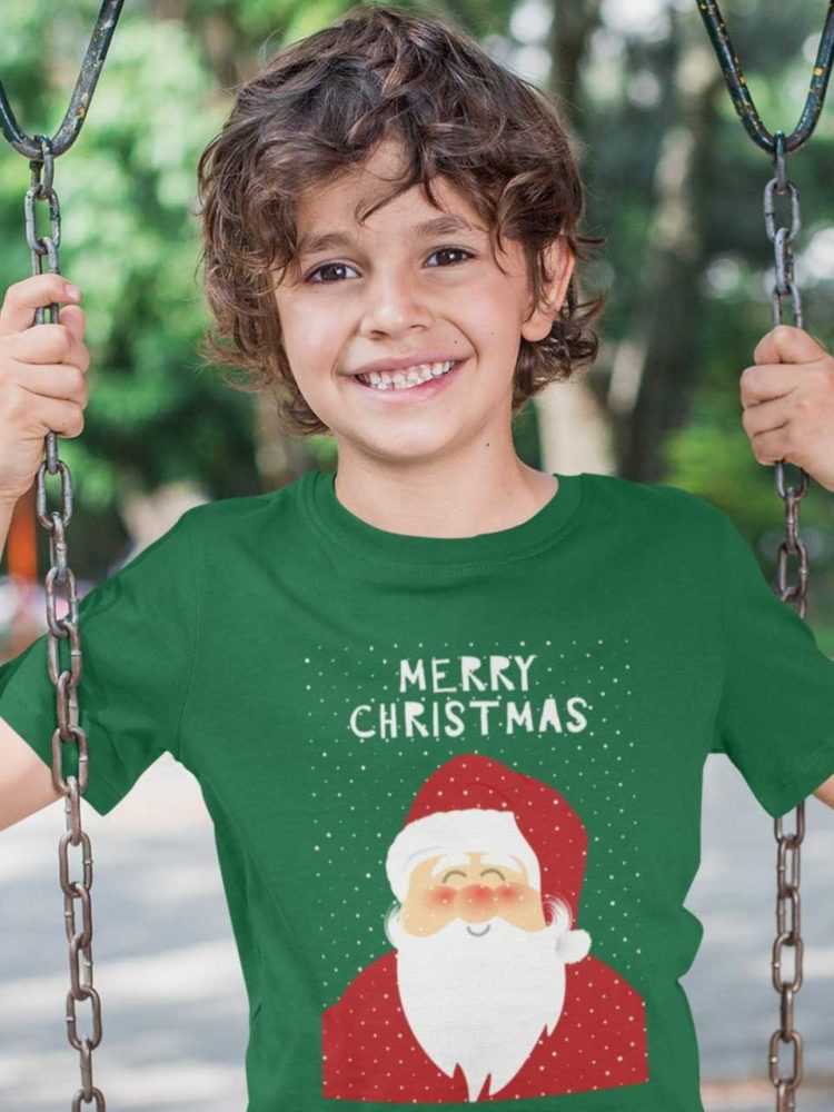 Smiling boy in a green tshirt with Santa and a Merry Christmas background