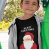 Sweet boy in a black tshirt with Santa and a Merry Christmas background