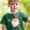 cute boy in a green tshirt with Santa holding a gift